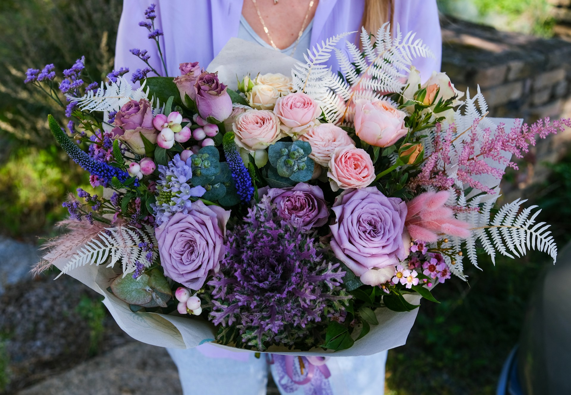 Lavender and blush wedding bouquet with roses and delicate foliage